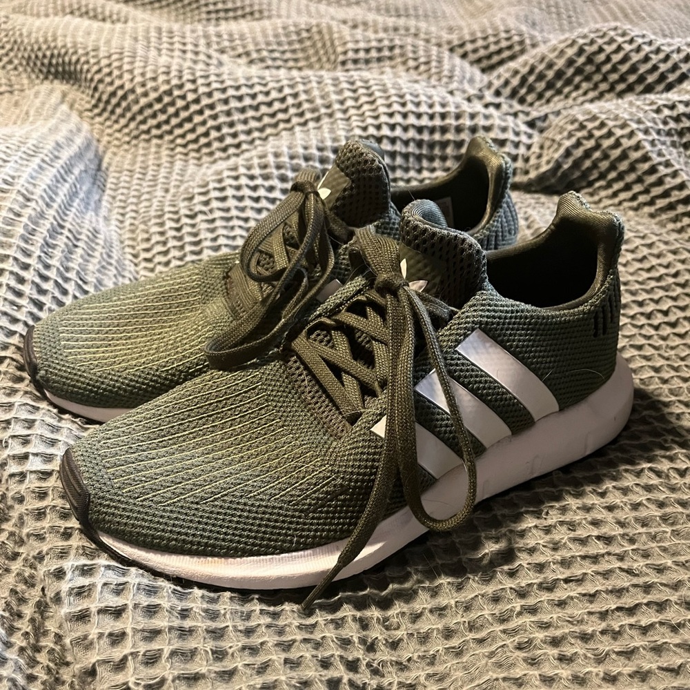 Forest green Adidas shoes.